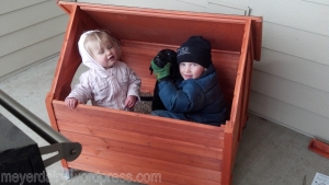 The kids helped build her dog house, and decided they liked it in there too!